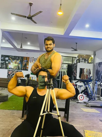 A classic gym mirror selfie with my big brother. We are powerlifters who train hard together.