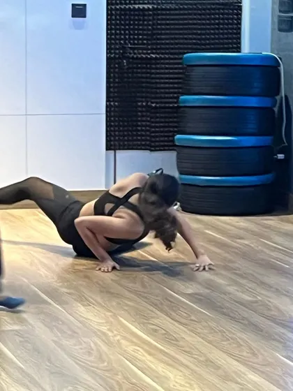A student practices floor work during a contemporary dance session, building strength and fluidity.