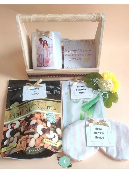 A thoughtful hamper for parents-to-be, designed to help them relax and enjoy some quiet time. This gift includes a personalized photo mug, a healthy nut mix, a face mask, and a soothing eye mask.