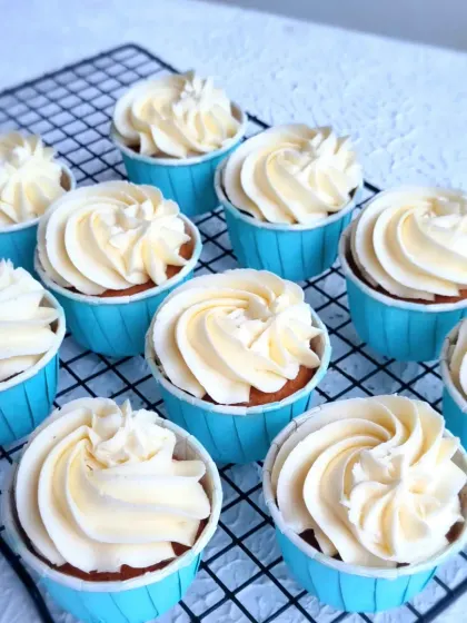 Simple vanilla cupcakes with buttercream frosting, ready to be decorated for the carnival-themed party.