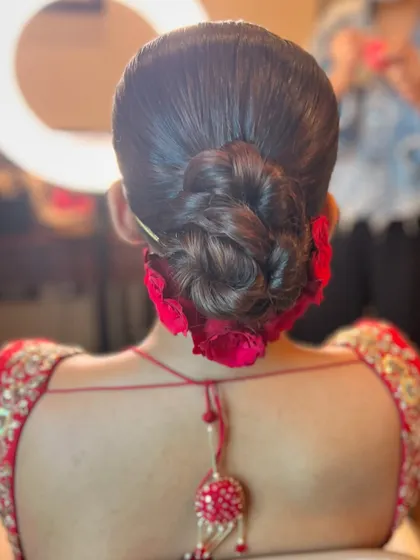 A back view of the braided rose bun, a perfect choice for a bride who wants a unique and romantic hairstyle.