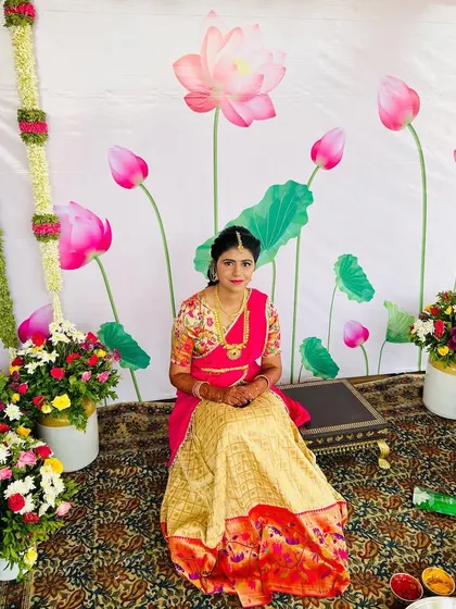 A wider shot showing the beautiful floral decor for the Pellikuthuru function. The bride's makeup is fresh and radiant.