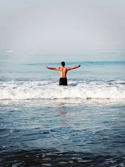 Embracing the ocean. A back shot showing the width and definition of my upper body.