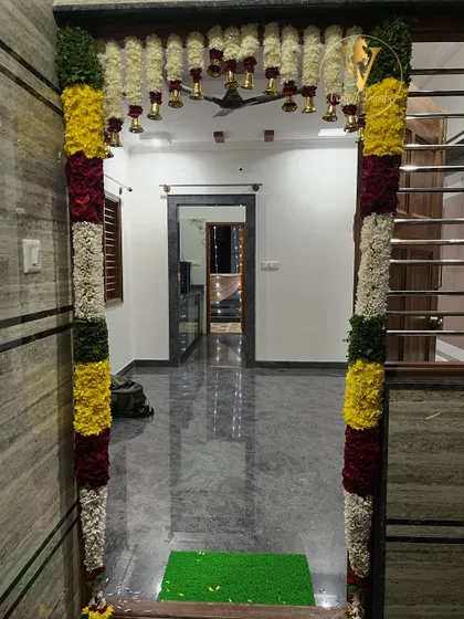 A traditional floral garland decoration for a housewarming (Gruha Pravesha) ceremony entrance.