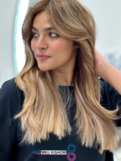 A final, gorgeous shot of this creamy peach ash blonde transformation. The hair is healthy, shiny, and perfectly styled.