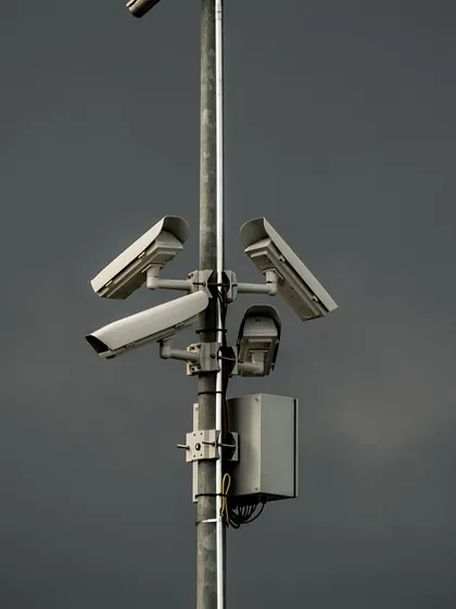 A pole-mounted camera setup against a dark sky, showing its readiness to protect your property in any weather.