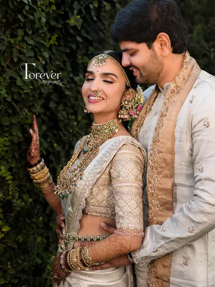 A happy, candid moment between the couple. The bride's glowing smile is the most beautiful accessory.