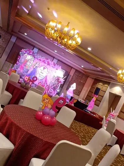 A look at the complete Barbie-themed party hall. I arranged the seating with themed centerpieces and ensured the entire venue was decorated to match the pink and purple princess aesthetic.