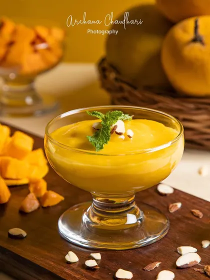 A close-up perspective that emphasizes the smooth, creamy texture of the mango puree. Detail shots like this are great for highlighting the quality and craftsmanship of a dish.
