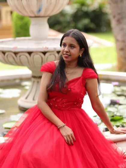 A close up shot of our client, looking radiant in her red gown. The delicate embroidery on the bodice adds a touch of sparkle.