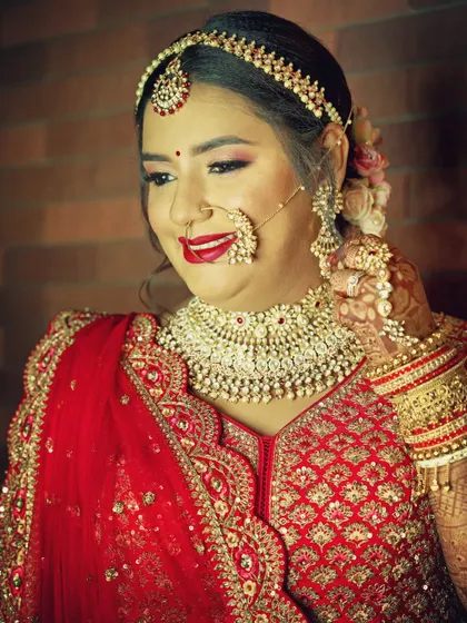 A classic bridal portrait capturing the elegance of the bride's attire. I focus on her expression and the fine details of her jewelry, like the nath and matha patti, to create a timeless image.