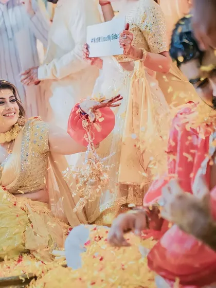 The bride's side making sure the groom gets his fair share of flowers and fun during the Haldi.