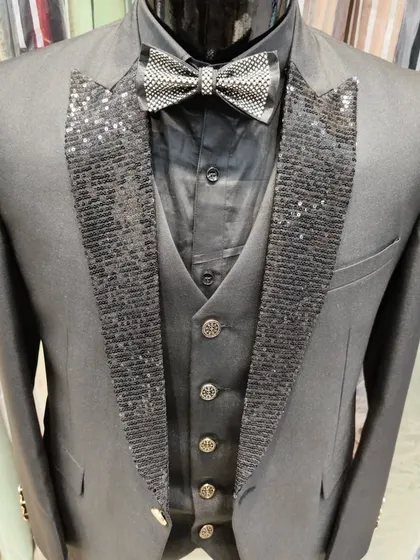 A collection of our designer suits, showcasing a variety of colors, fabrics, and custom details like embroidery, unique lapels, and accessories. Each piece is crafted to make a lasting impression.