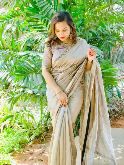 A closer look at the client's beige saree, showing the texture of the fabric.