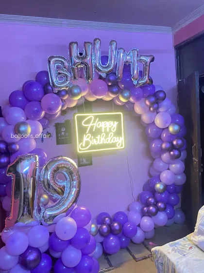 A full view of the 19th birthday setup, including foil balloons spelling out the name 'BHUMI'.