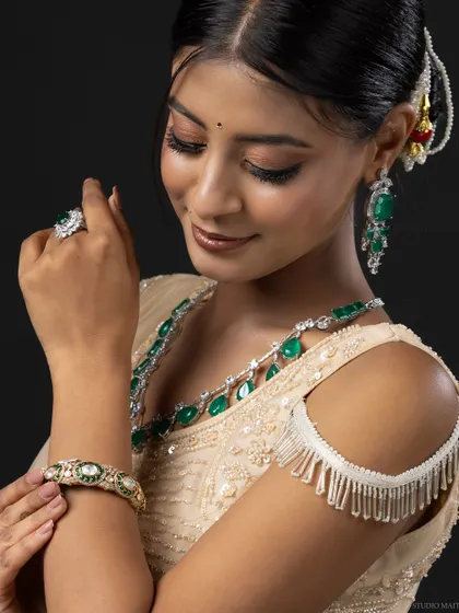 A portrait of the model admiring her emerald bangle, a great shot for a jewellery brand.
