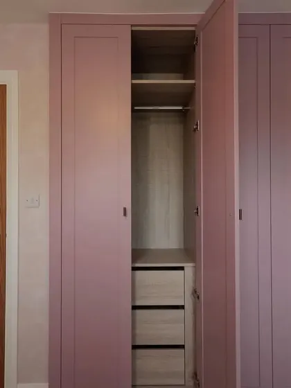 Another interior view, highlighting the combination of hanging space and deep drawers for versatile storage.