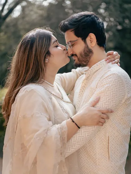A sweet kiss on the nose, a simple gesture of affection captured in a beautiful, naturally lit outdoor setting.