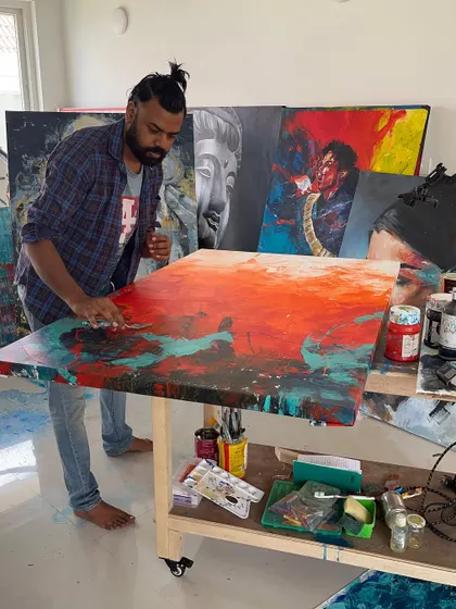 Using a palette knife to spread vibrant red paint across the canvas. This tool is essential for creating the heavily textured surfaces in many of my works.