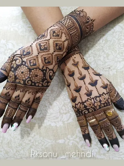 A playful and festive design featuring hanging diya lamps on one hand and a beautiful floral and geometric pattern on the other. This is a great choice for Diwali or other celebrations.
