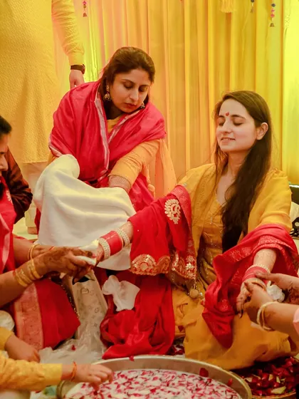 The Chooda ceremony is a significant and emotional ritual. Here, we document the bride's family lovingly placing the traditional red and white bangles on her wrists, a beautiful moment of blessing.