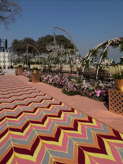 A vibrant, custom-designed chevron-patterned carpet for the walkway, adding a bold and colorful element to the wedding decor.