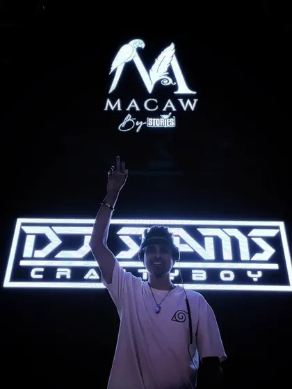 They call it DJing, but for me, it's an art form. A powerful shot under my logo at Macaw, signifying my brand and my passion.