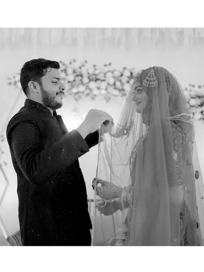 A duplicate of the previous shot, emphasizing the quiet, caring gesture between the bride and groom during their ceremony.