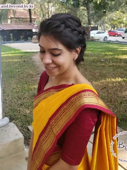 This client's smile says it all. The messy updo with a crown braid is a comfortable and stylish choice that allows you to enjoy the wedding festivities without worrying about your hair.