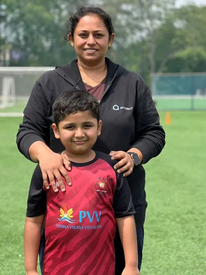 A mother stands proudly with her son. Our events are designed to include families and celebrate the supportive community around our players.