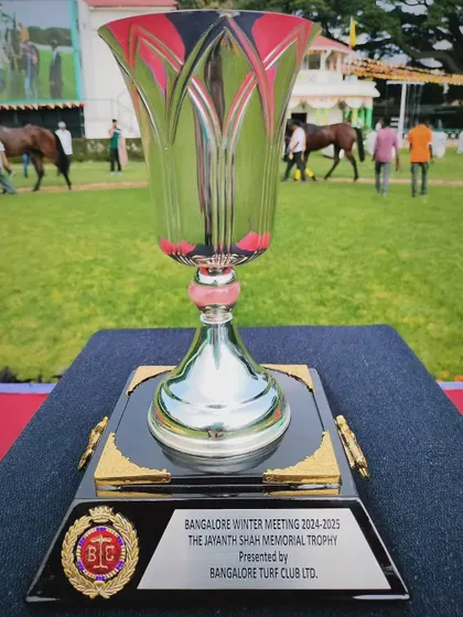The Jayant Shah Memorial Trophy, a beautiful glass cup with pink and clear fluting.