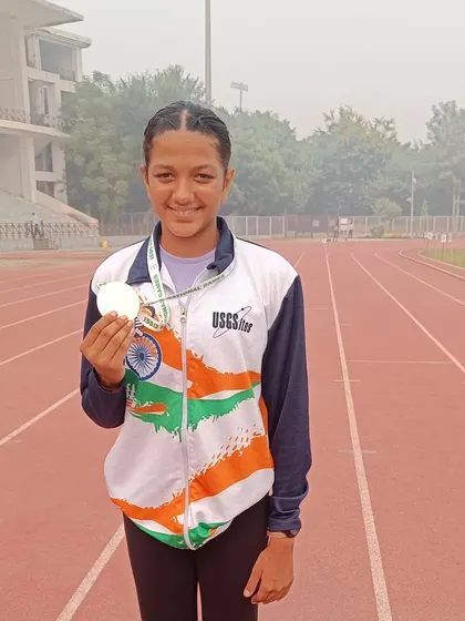 Sanisska proudly holding her medal after a stellar performance at the ISSO National Games.
