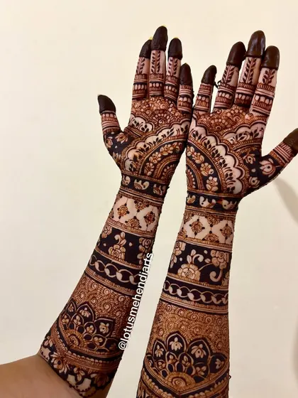 A different angle showcasing the beautiful design that extends up the arms, creating a complete and elegant bridal look.