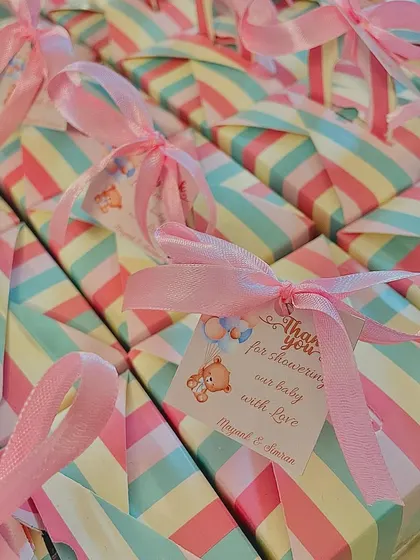 A close-up of the baby shower favor box, showing the cute teddy bear tag.