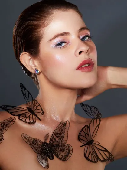 A delicate and whimsical look with a soft wash of color on the eyes and beautiful butterfly appliques on the body.