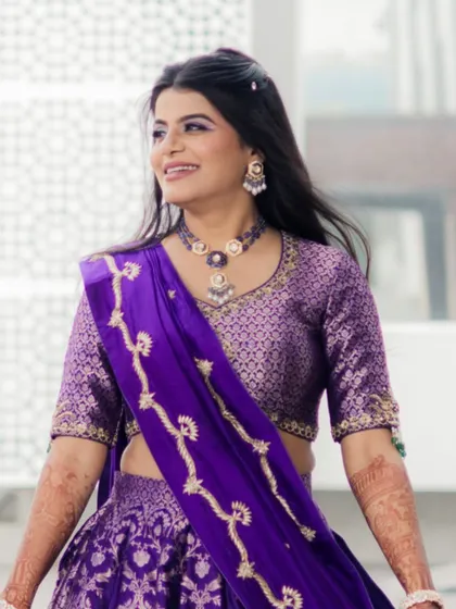 Another beautiful shot of the bride's haldi look. The open hairstyle is decorated with small, subtle accessories.