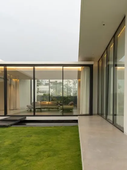 This "H-Shaped" house is designed around two courtyards. This view shows the private, intimate courtyard, a green space that brings light and nature directly into the living areas while maintaining a sense of enclosure and privacy.