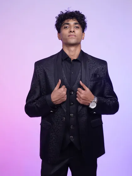 A classic black tuxedo that always gets it right. The patterned jacket and sharp tailoring make this a timeless choice for any black-tie event.