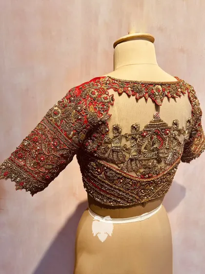 A different angle of the wedding procession blouse, highlighting the masterful detail of the zardosi threads and shimmering beads.