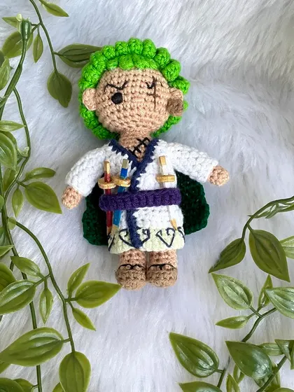 Roronoa Zoro from One Piece in a different outfit. This version features his white kimono, green cape, and of course, his three swords. It's always exciting to create new designs for a character.