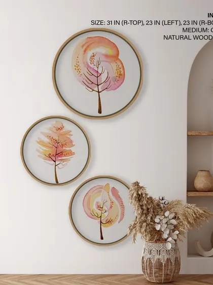 This set of three circular prints features whimsical watercolor trees in warm, fluid colors. The artistic and dreamy designs, framed in natural wood, add a soft and imaginative touch to the room.
