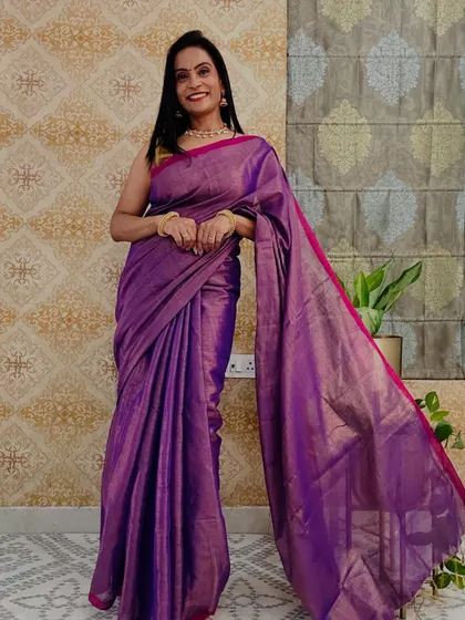 This purple tissue saree with a pink border is a very rich and royal color combination. It's a great festive wear option at a budget-friendly price.