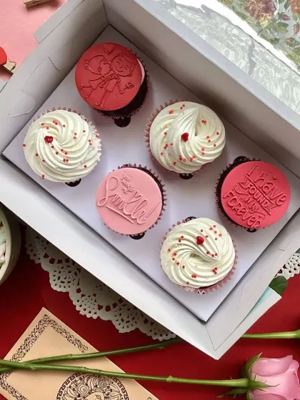 Say it with cupcakes this Valentine's Day. This box features a mix of beautifully frosted cupcakes and others with custom-stamped messages.