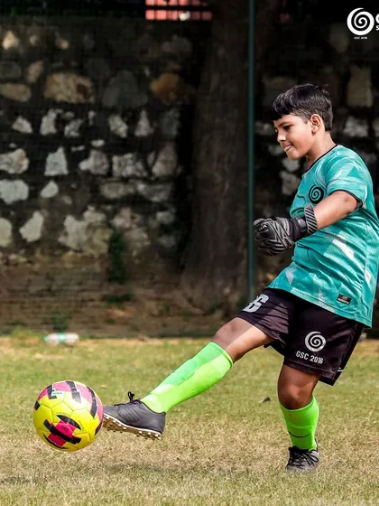 A young keeper practices their goal kicks, a fundamental skill for the position.