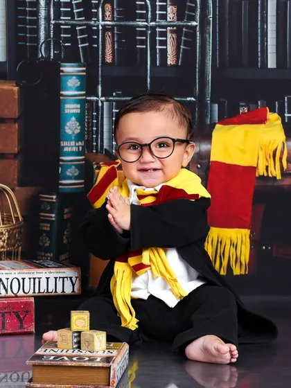 A round of applause for our newest Gryffindor. This little wizard's happy expression and clapping hands perfectly capture the magic of the moment.