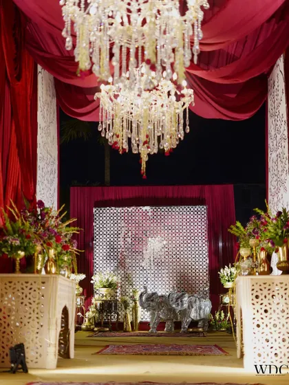 A glimpse into an era of love and passion. This entrance features shimmering elephant statues, grand chandeliers, and rich red drapes, creating a truly royal and indulgent experience.