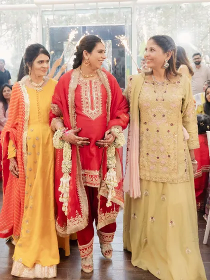 A candid shot of the Godh Bharai entry, filled with smiles and love.