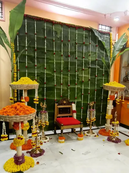 This setup is for a traditional Devkarya puja, where authenticity is key. I use a fresh banana leaf backdrop, stands filled with marigolds, and traditional brass lamps to create a sacred and beautiful space for pre-wedding rituals.