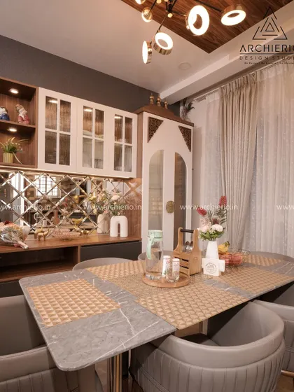 A dining area with a unique foldable table, perfect for small spaces, complemented by a crockery unit with a diamond-patterned mirror backsplash.