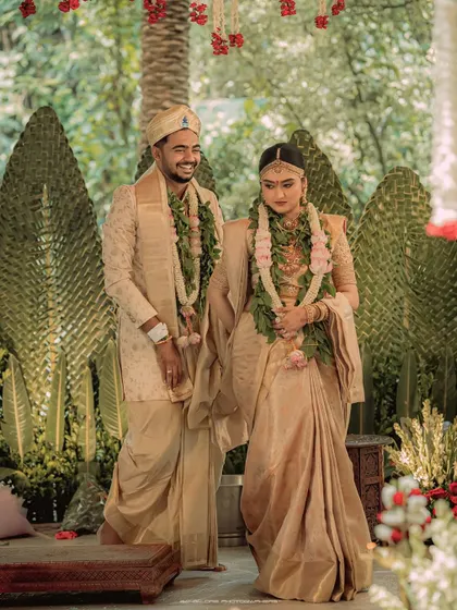 A beautiful moment of connection between the bride and groom. Their coordinated golden attire shines in this elegant portrait taken at Chamaravarjra.